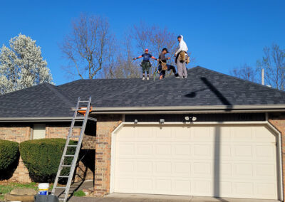 Newly completed residential roof with a fresh black shingle finish in Springfield, MO.