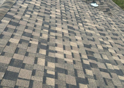 Close-up of brown asphalt shingles on a residential roof installed by Roof For Less.