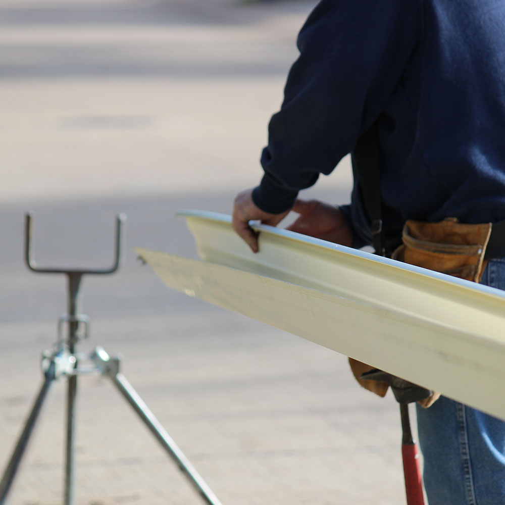 Technician installing TPO roofing materials on a flat roof in Springfield, MO, emphasizing Roof For Less's high-quality flat roof replacement services.