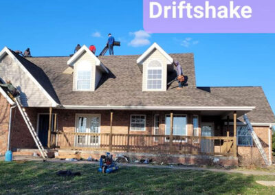 Roofing team working on a steep-pitched roof with IKO Dynasty Driftshake shingles.