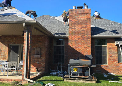 Roofing team installing new shingles on a residential home in Springfield, MO.