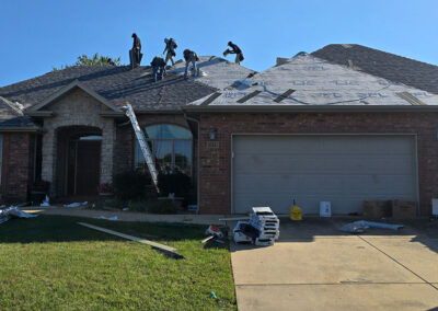 Roofers completing a shingle roof project in Springfield, MO.