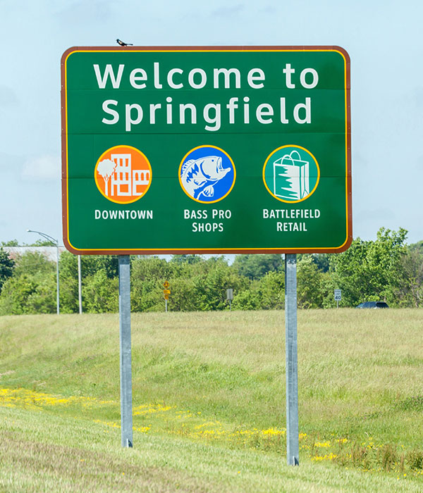 Welcome to Springfield, MO sign along the highway, representing Roof For Less's service coverage across Missouri communities.